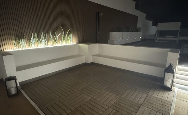 Beautifully lit gardens and poolside ambiance at night